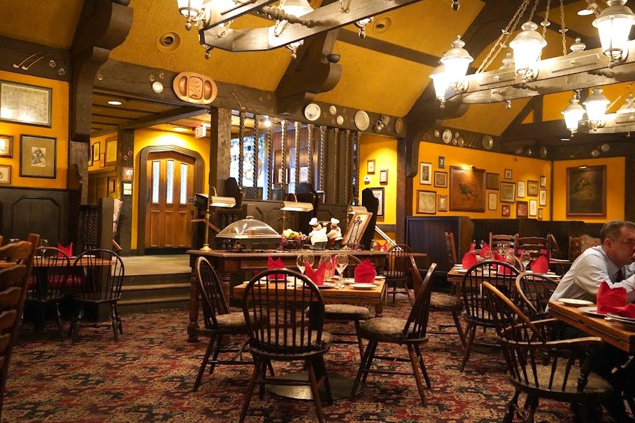 Timber-beamed room with hanging lanterns and red napkins at Gulliver's